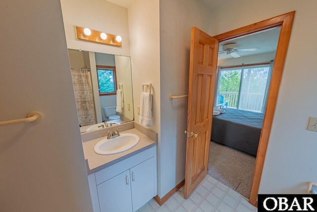 bathroom featuring toilet, vanity, and ceiling fan