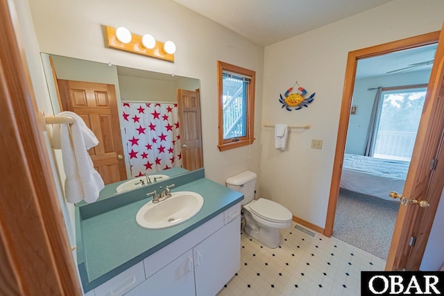 ensuite bathroom with tile patterned floors, vanity, baseboards, toilet, and visible vents