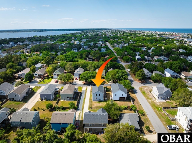 aerial perspective of suburban area with a nearby body of water