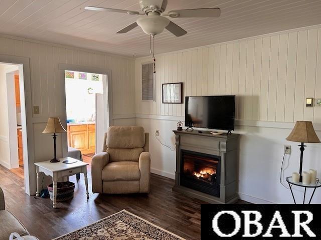 690 Irvin Garrish Hwy Lot # 2A, Ocracoke, NC 27960 - living area featuring wood finished floors, a warm lit fireplace, and a ceiling fan