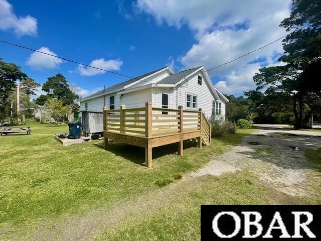 690 Irvin Garrish Hwy Lot # 2A, Ocracoke, NC 27960 - view of home's exterior featuring a deck and a lawn