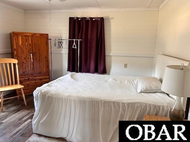 690 Irvin Garrish Hwy Lot # 2A, Ocracoke, NC 27960 - bedroom featuring wood finished floors, ornamental molding, and wooden walls