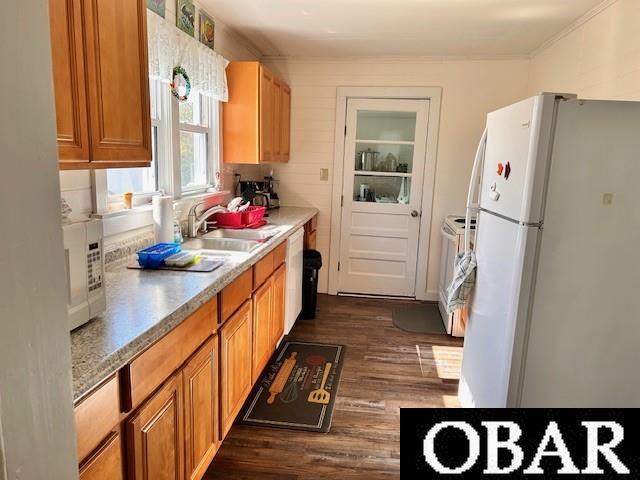 690 Irvin Garrish Hwy Lot # 2A, Ocracoke, NC 27960 - kitchen with white appliances, a sink, dark wood-type flooring, light countertops, and brown cabinets