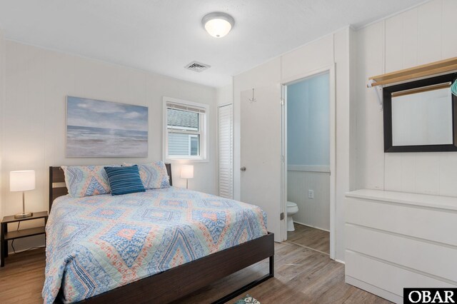 111 Carlow Ave Lot 18, Kill Devil Hills, NC 27948 - bedroom with wood finished floors, a decorative wall, and ensuite bath