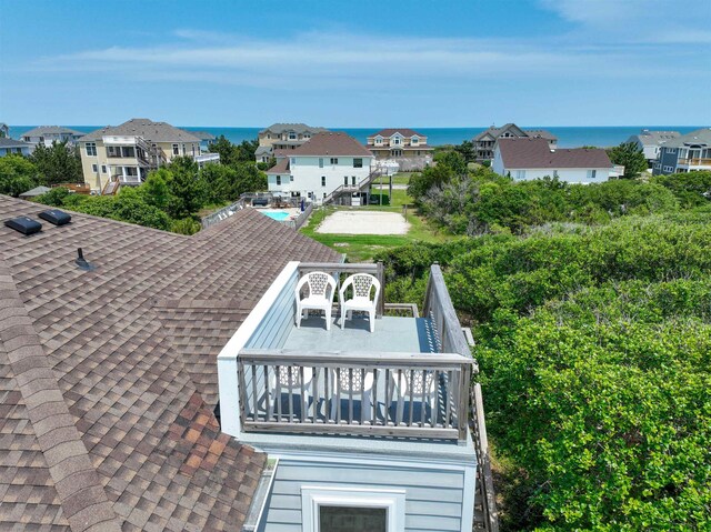 exterior details with a residential view and roof with shingles