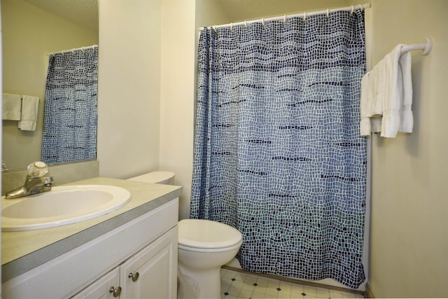 bathroom with toilet, curtained shower, and vanity