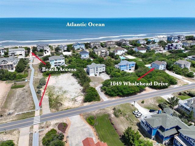 bird's eye view featuring a water view and a residential view