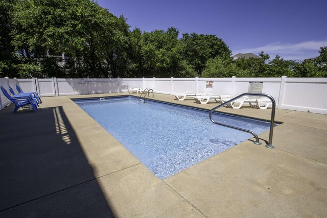 view of pool featuring a fenced in pool, a fenced backyard, and a patio