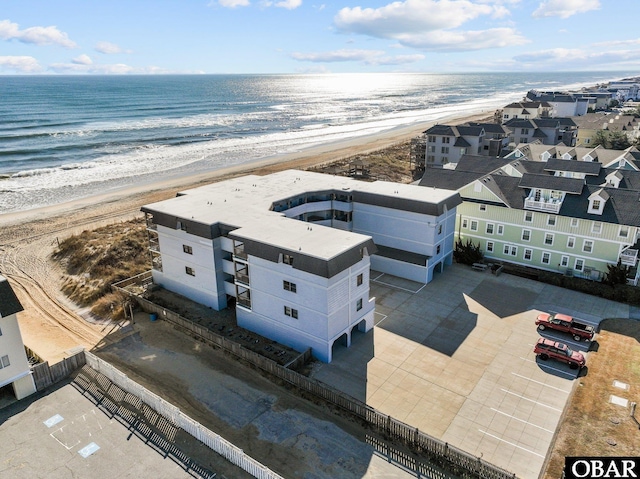 drone / aerial view with a beach view and a water view