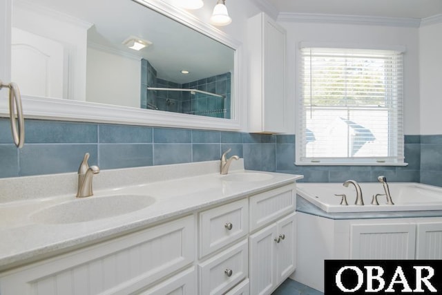 bathroom with double vanity, a stall shower, ornamental molding, and a sink