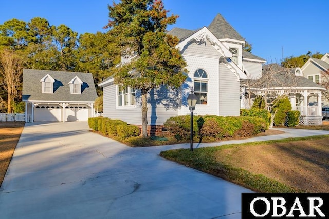 view of front of home with a garage and a front lawn