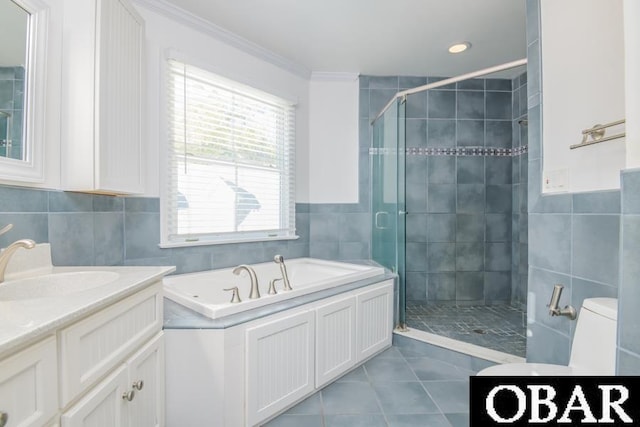 bathroom featuring tile walls, ornamental molding, a stall shower, vanity, and tile patterned flooring