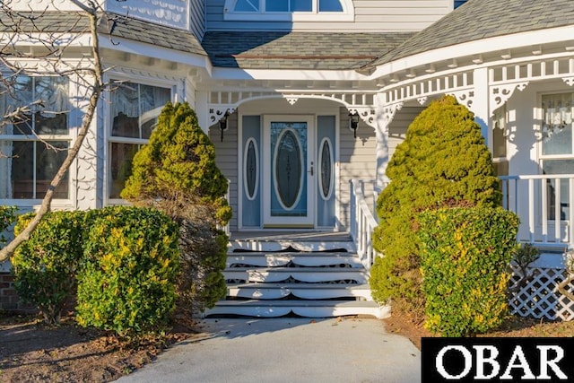 entrance to property with roof with shingles