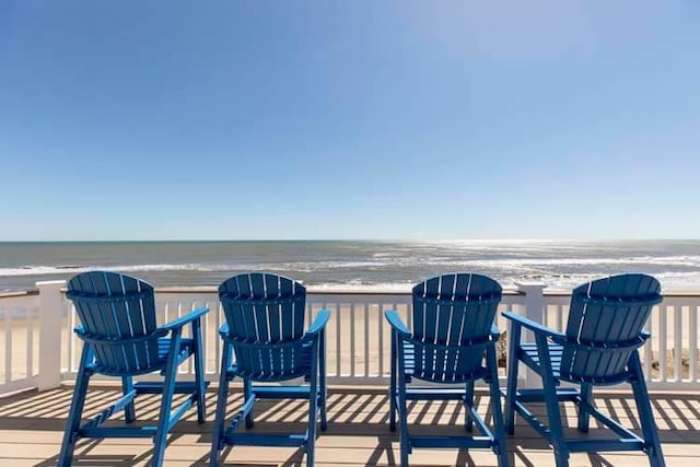 wooden deck with a view of the beach and a water view