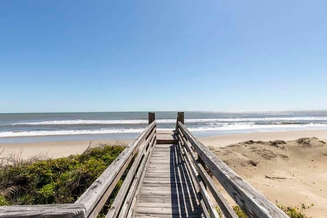 surrounding community featuring a view of the beach and a water view