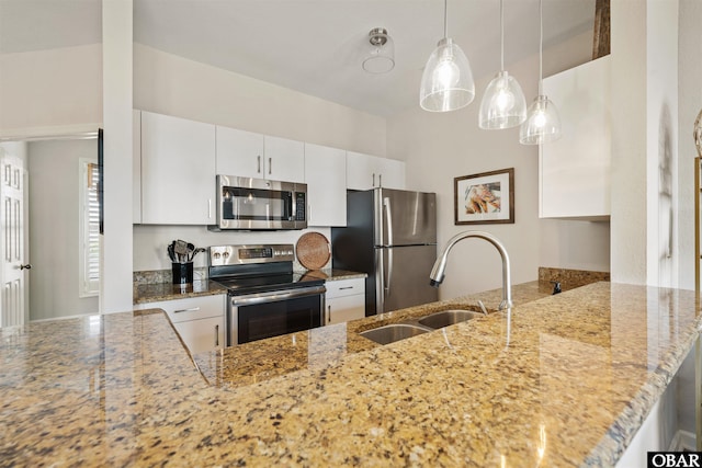 1113 Pirates Way Unit 1113, Manteo, NC 27954 - kitchen with stainless steel appliances, a sink, a peninsula, and light stone counters