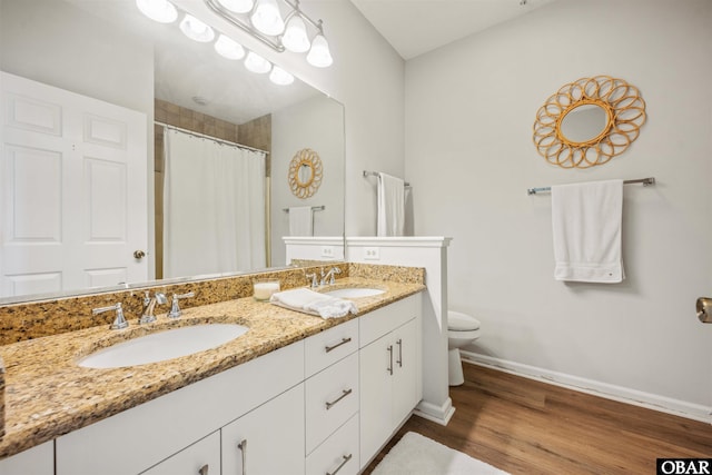 1113 Pirates Way Unit 1113, Manteo, NC 27954 - bathroom featuring toilet, double vanity, wood finished floors, baseboards, and curtained shower