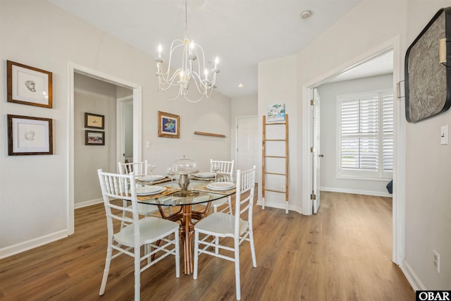 1113 Pirates Way Unit 1113, Manteo, NC 27954 - dining area featuring wood finished floors, baseboards, and a chandelier