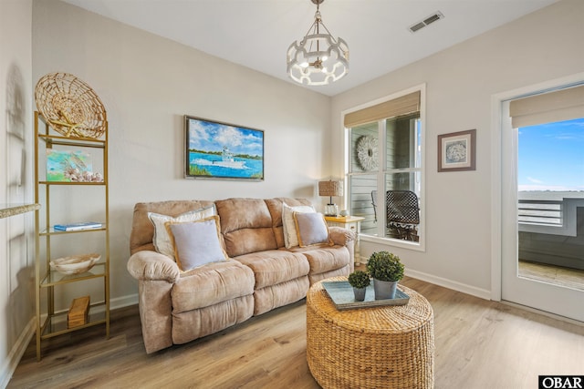 1113 Pirates Way Unit 1113, Manteo, NC 27954 - living area featuring light wood finished floors, baseboards, and a chandelier