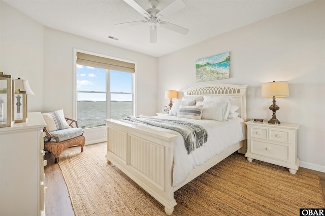 1113 Pirates Way Unit 1113, Manteo, NC 27954 - bedroom with light wood-type flooring, baseboards, and ceiling fan
