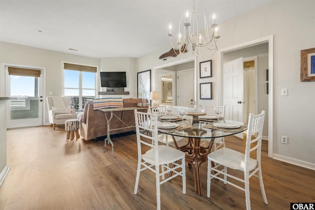 1113 Pirates Way Unit 1113, Manteo, NC 27954 - dining room featuring a chandelier, wood finished floors, and baseboards