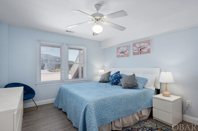 bedroom featuring a ceiling fan, light wood-type flooring, visible vents, and baseboards