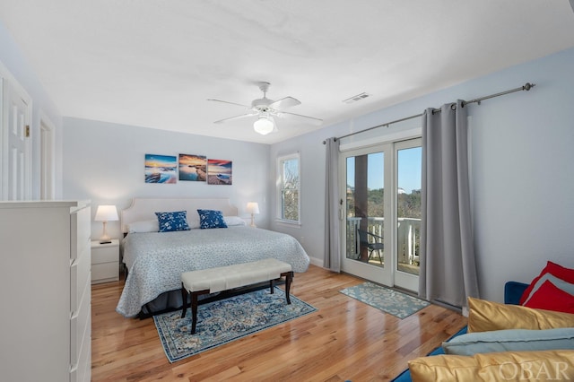 bedroom with visible vents, baseboards, ceiling fan, wood finished floors, and access to exterior