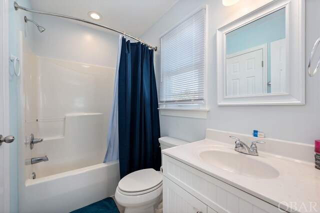 bathroom with toilet, shower / tub combo with curtain, and vanity