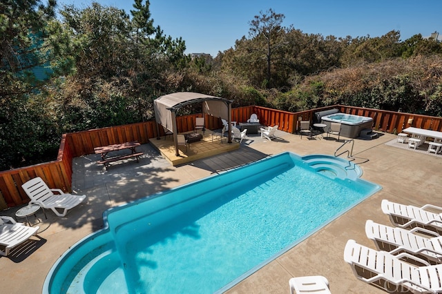 view of swimming pool featuring a fenced backyard, outdoor lounge area, an outdoor hot tub, a gazebo, and a fenced in pool