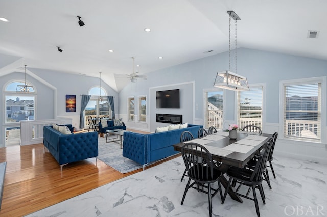 dining area featuring visible vents, lofted ceiling, a wainscoted wall, marble finish floor, and recessed lighting