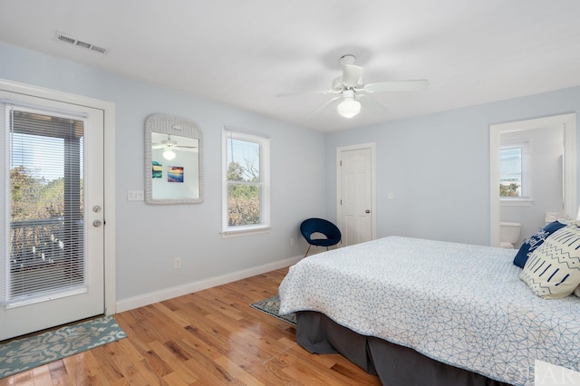 bedroom featuring baseboards, visible vents, a ceiling fan, wood finished floors, and access to outside