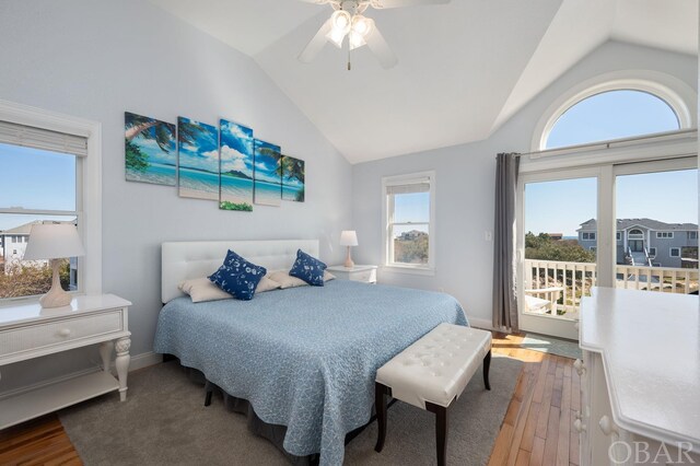 bedroom featuring baseboards, a ceiling fan, lofted ceiling, wood finished floors, and access to outside