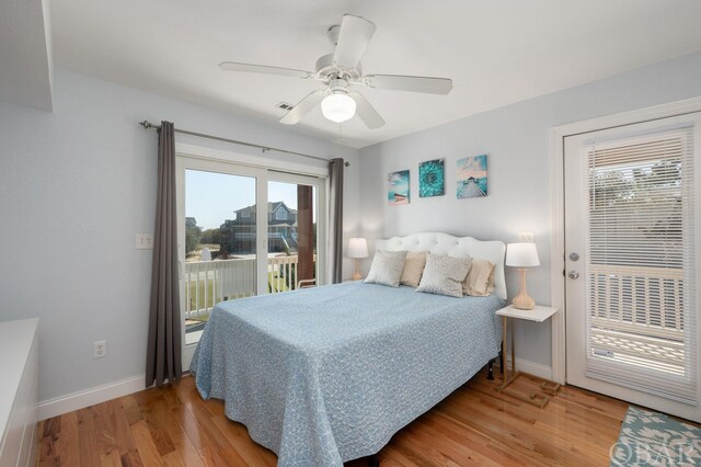 bedroom featuring access to exterior, a ceiling fan, baseboards, and wood finished floors