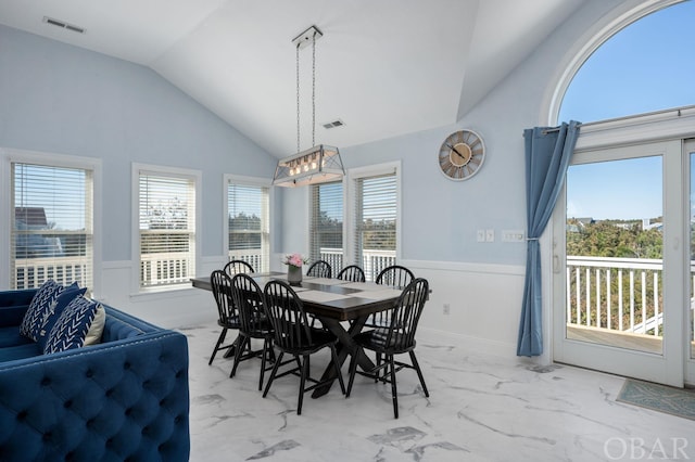 dining room featuring marble finish floor, wainscoting, and visible vents