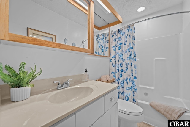 bathroom with toilet, a textured ceiling, vanity, and shower / bathtub combination with curtain