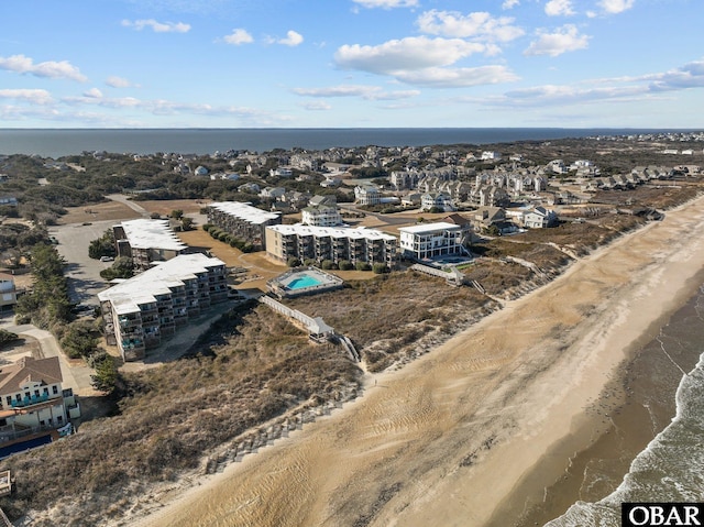 birds eye view of property featuring a water view and a beach view