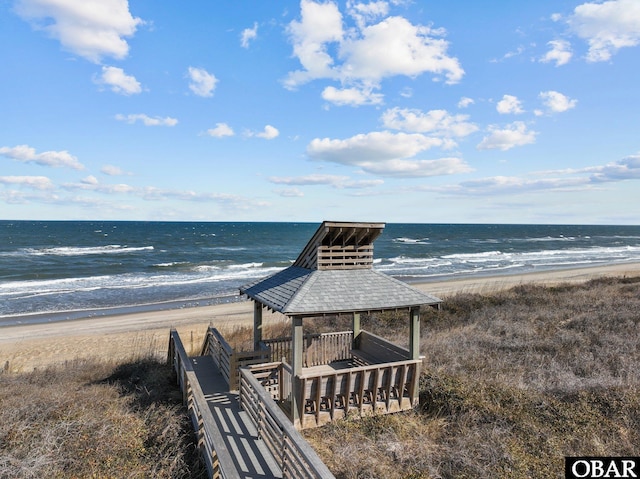 view of water feature featuring a view of the beach and a gazebo