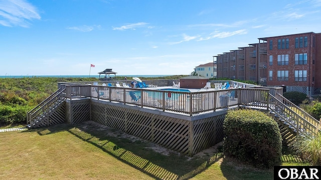 community pool with a yard and stairway