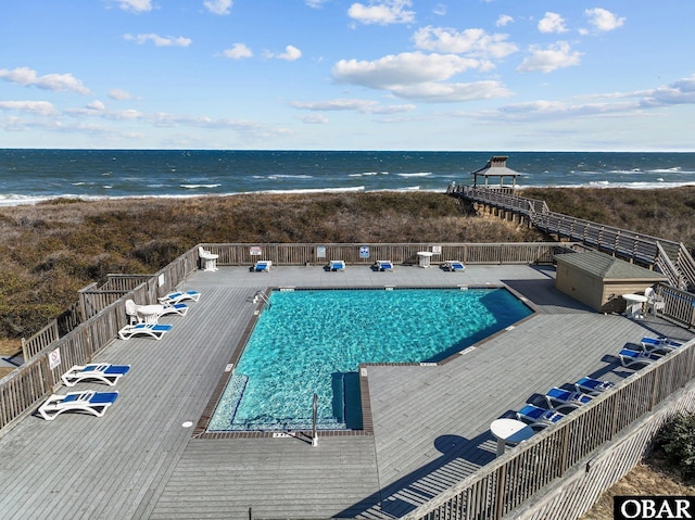 pool featuring a water view and fence