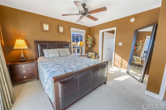 bedroom with a ceiling fan, light colored carpet, visible vents, and baseboards