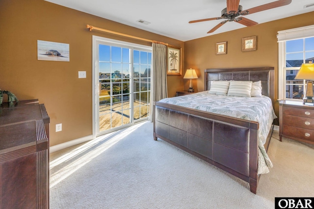 bedroom with access to outside, light colored carpet, ceiling fan, and baseboards