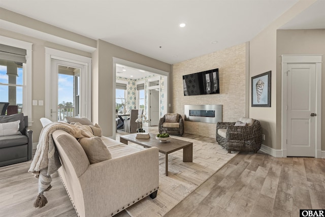 202 Dartmoor Ave Unit 202-C, Manteo, NC 27954 - living area featuring light wood-type flooring, a fireplace, recessed lighting, and baseboards