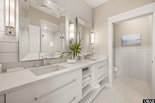 202 Dartmoor Ave Unit 202-C, Manteo, NC 27954 - bathroom featuring toilet, a wainscoted wall, double vanity, and wood walls