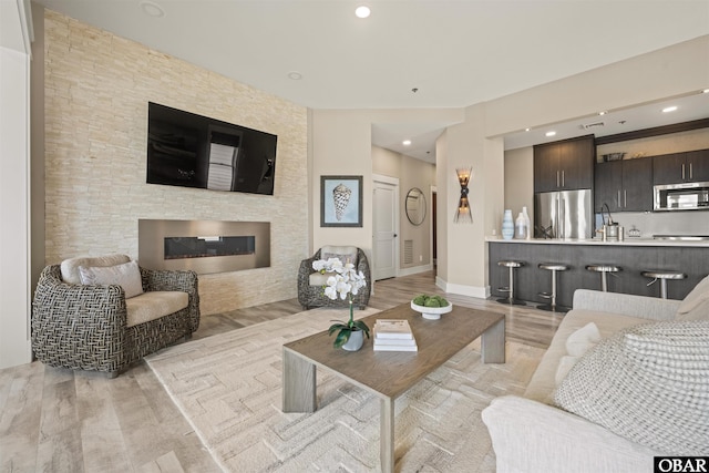 202 Dartmoor Ave Unit 202-C, Manteo, NC 27954 - living area with a fireplace, light wood-style flooring, baseboards, and recessed lighting