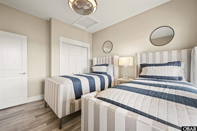 202 Dartmoor Ave Unit 202-C, Manteo, NC 27954 - bedroom with wood finished floors, attic access, baseboards, and a closet