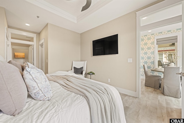 202 Dartmoor Ave Unit 202-C, Manteo, NC 27954 - bedroom featuring light wood finished floors, baseboards, ceiling fan, a raised ceiling, and recessed lighting