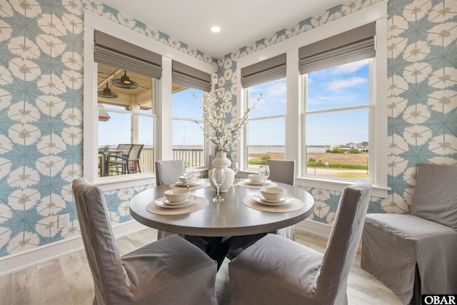 202 Dartmoor Ave Unit 202-C, Manteo, NC 27954 - dining room with light wood finished floors, baseboards, wallpapered walls, and recessed lighting