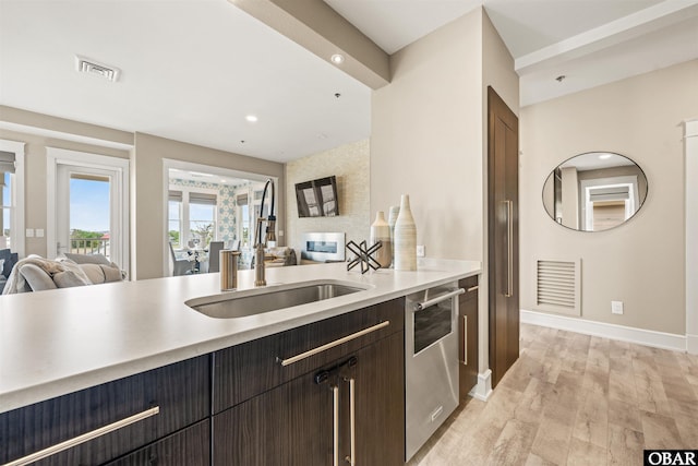 202 Dartmoor Ave Unit 202-C, Manteo, NC 27954 - kitchen featuring open floor plan, a sink, stainless steel dishwasher, light countertops, and recessed lighting