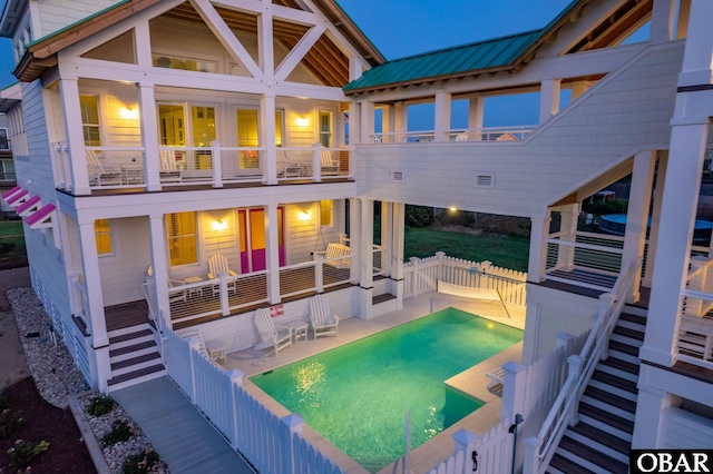 5118 N Virginia Dare Trl Lot 7, Kitty Hawk, NC 27949 - back of house with a balcony, a fenced backyard, a metal roof, and a patio area