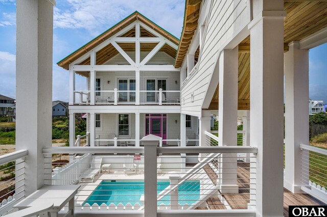 5118 N Virginia Dare Trl Lot 7, Kitty Hawk, NC 27949 - rear view of house with a community pool and a balcony